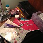Jen Chung's nightstand: "tissues, a nickel, NyQuil, Ricola, a clock, The New Yorker, Netflix, cream, paint-splattered Hello Kitty box for bobby pins, pencil and eraser for when I sketch, lucky money envelope, lip balm, Vitamin C, Vitamin C, Wildlife conservation society membership renewal I should throw out bc I renewed on line but its under other shit so I forget."